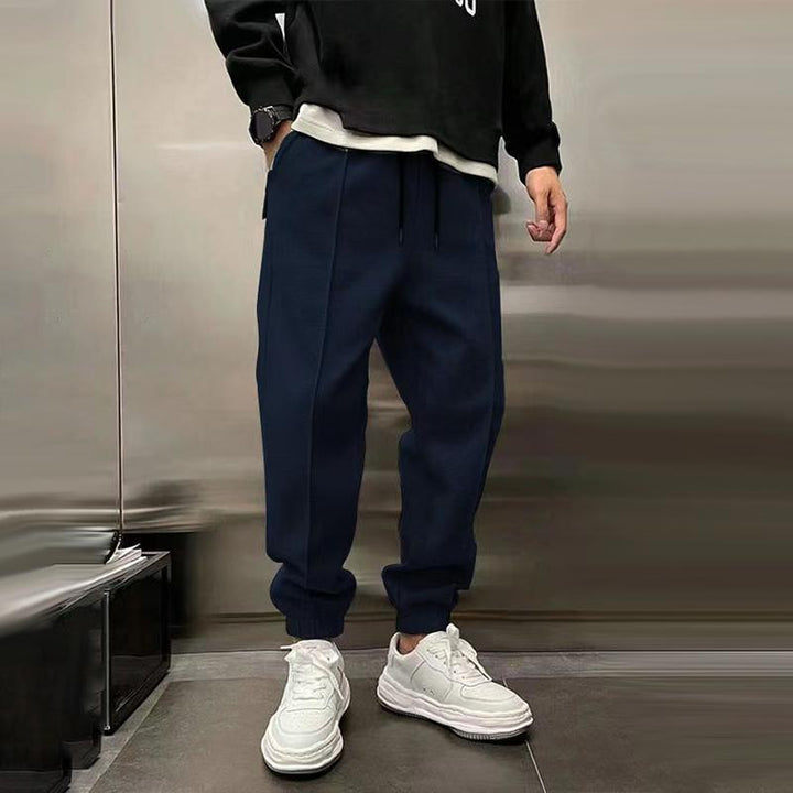 Lifestyle image of man walking in relaxed fit casual trousers, showcasing freedom of movement