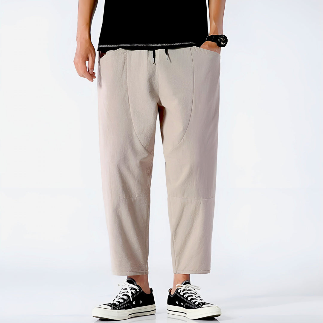 Men's modern cropped drawstring chinos, relaxed fit, styled for comfortable summer fashion.