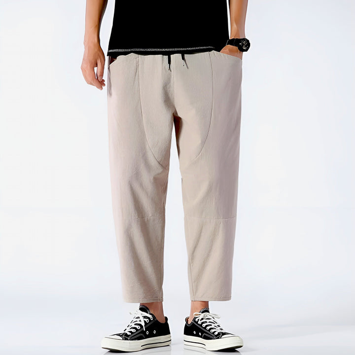 Men's modern cropped drawstring chinos, relaxed fit, styled for comfortable summer fashion.