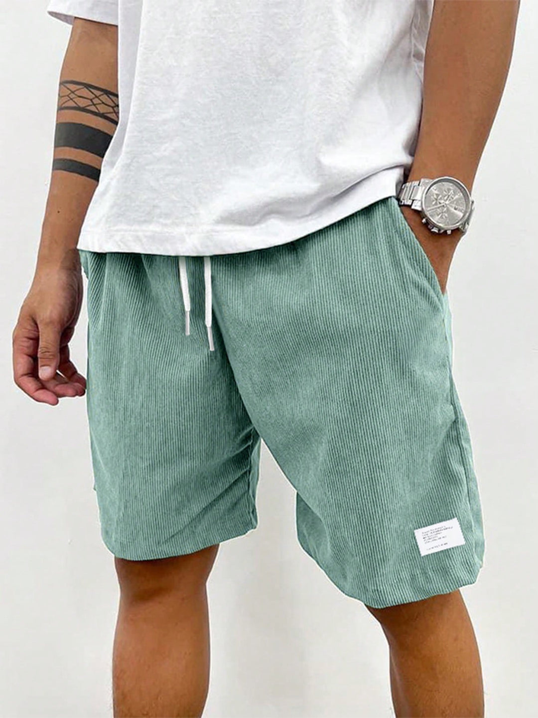 Stack of folded men's casual drawstring shorts in various colors, showcasing relaxed fit and soft fabric.