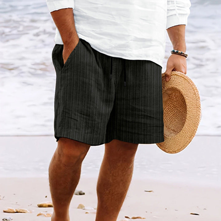 Modern men's fashion: relaxed fit drawstring shorts, combining comfort & casual style.