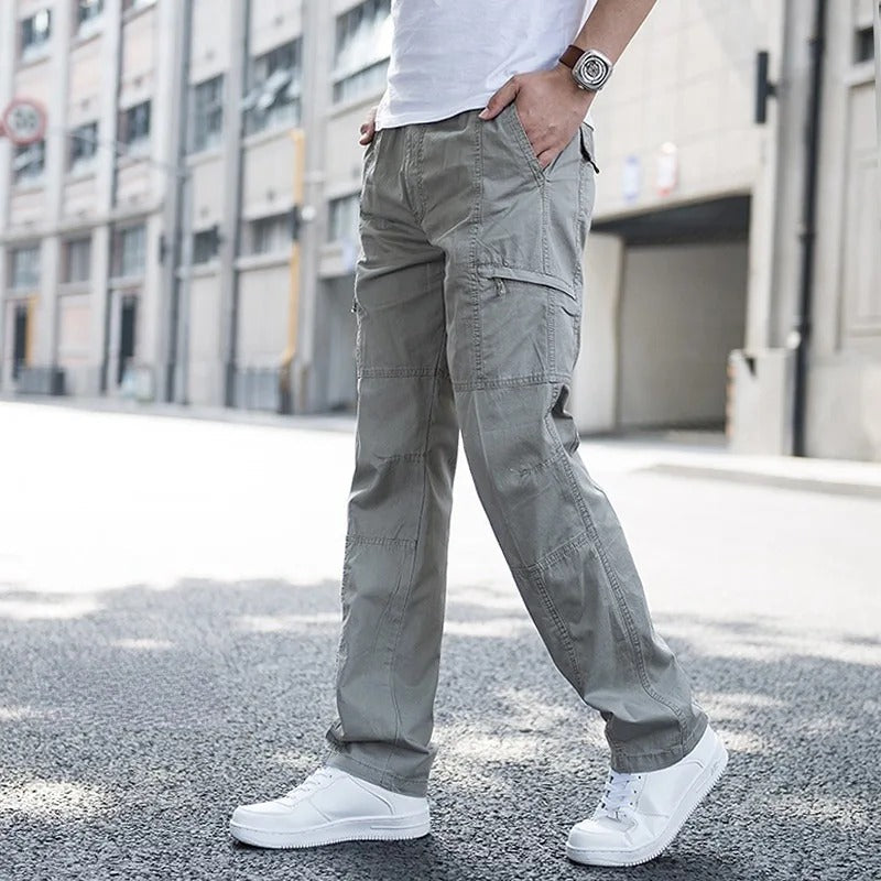 Male model wearing black relaxed fit organic cotton cargo pants, casual pose