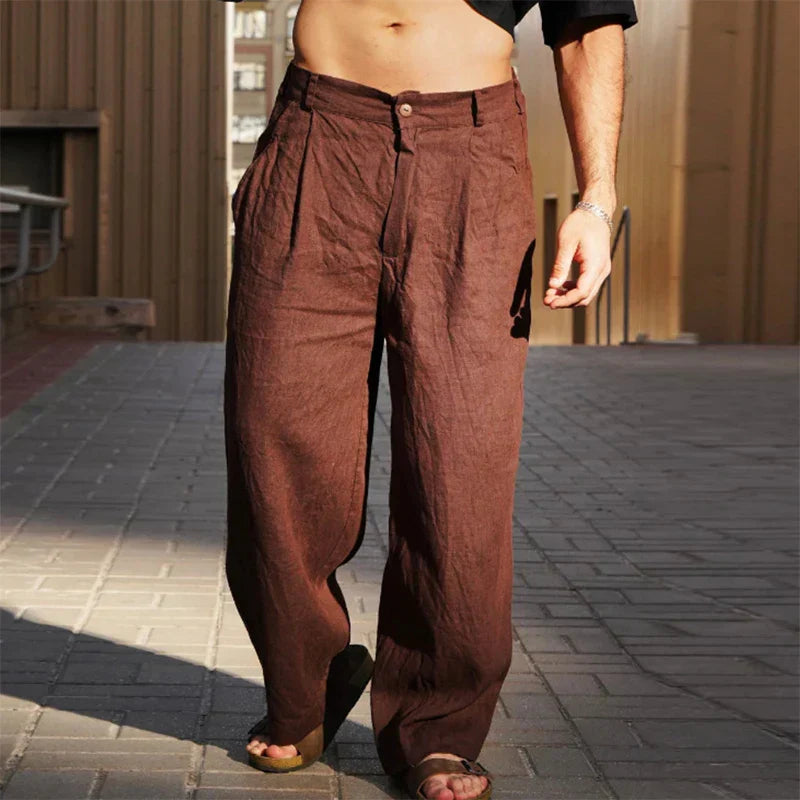 Men's relaxed fit pleated linen trousers in a light color, ideal for summer fashion.