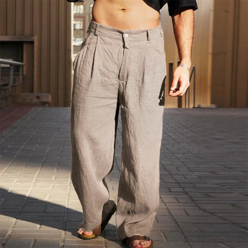 Side profile of men's comfortable linen pants, showcasing the pleat detail.