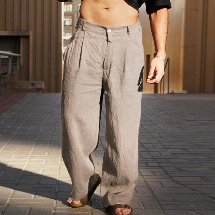 Side profile of men's comfortable linen pants, showcasing the pleat detail.