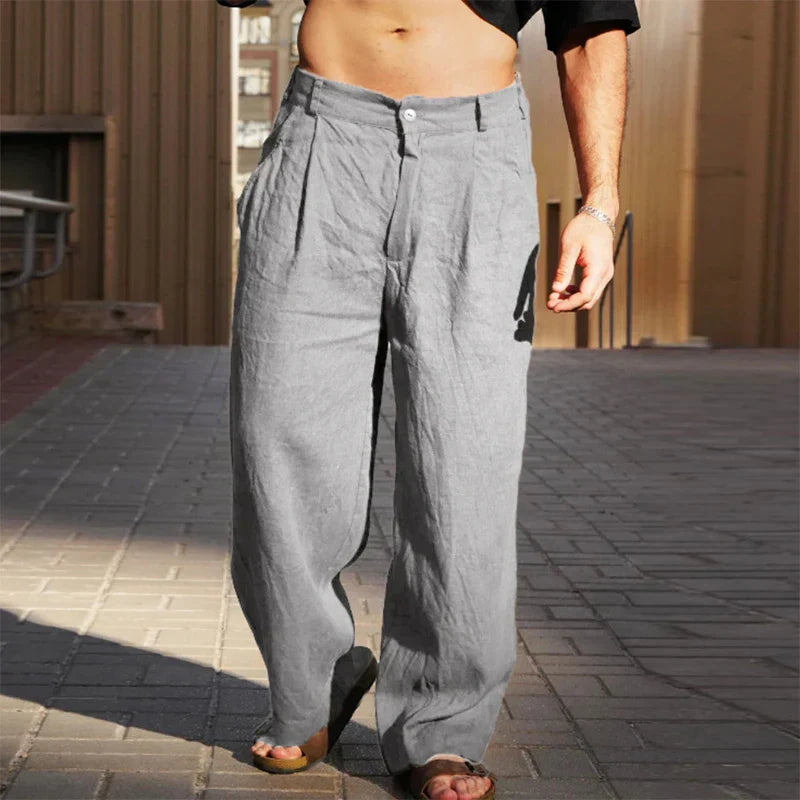 Close-up of the breathable linen fabric on men's relaxed fit trousers.