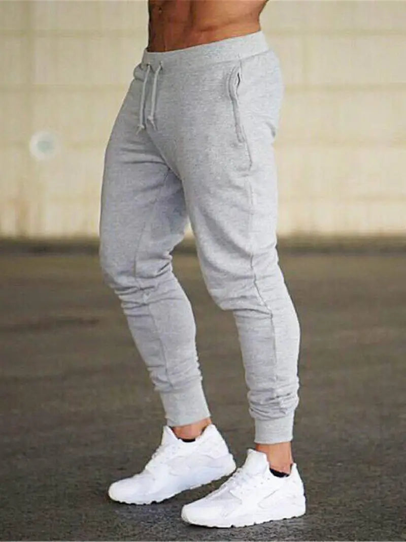 Men's relaxed fit sports jogger pants in black with tapered leg, perfect for active wear or casual lounging.