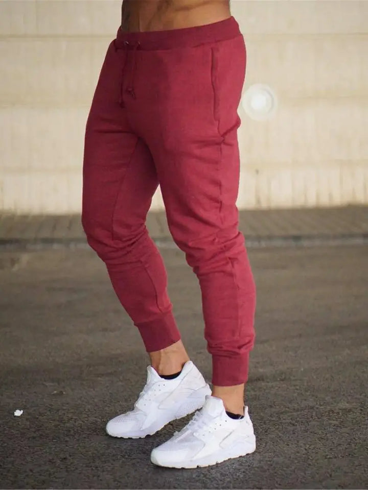 Grey relaxed fit men's sports joggers featuring a tapered leg, suitable for active wear, lounge, or casual style.