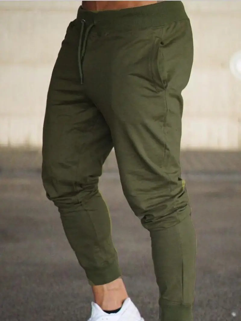Close-up of the fabric texture and tapered leg detail on men's relaxed fit sports jogger pants, versatile activewear.