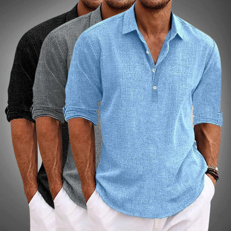 Detail of a men's solid color relaxed summer shirt, showcasing the half placket and roll tab sleeve features.