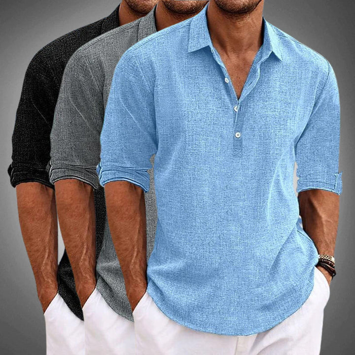 Detail of a men's solid color relaxed summer shirt, showcasing the half placket and roll tab sleeve features.