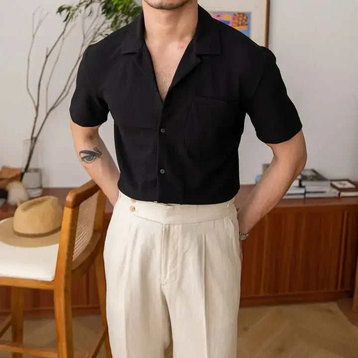 Modern men's casual button shirt, relaxed fit, textured fabric, short sleeve, open collar. Versatile menswear.