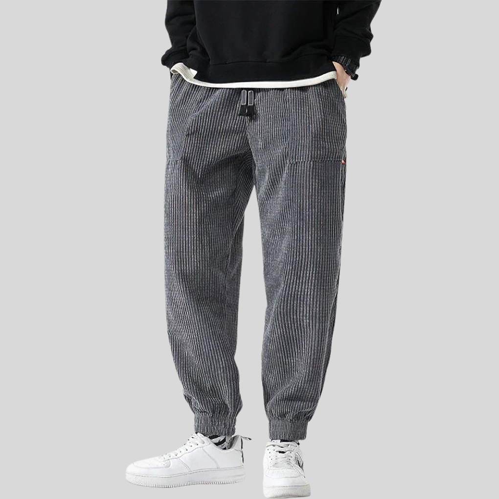 Comfortable men's black corduroy joggers with a wide leg and elastic waistband.
