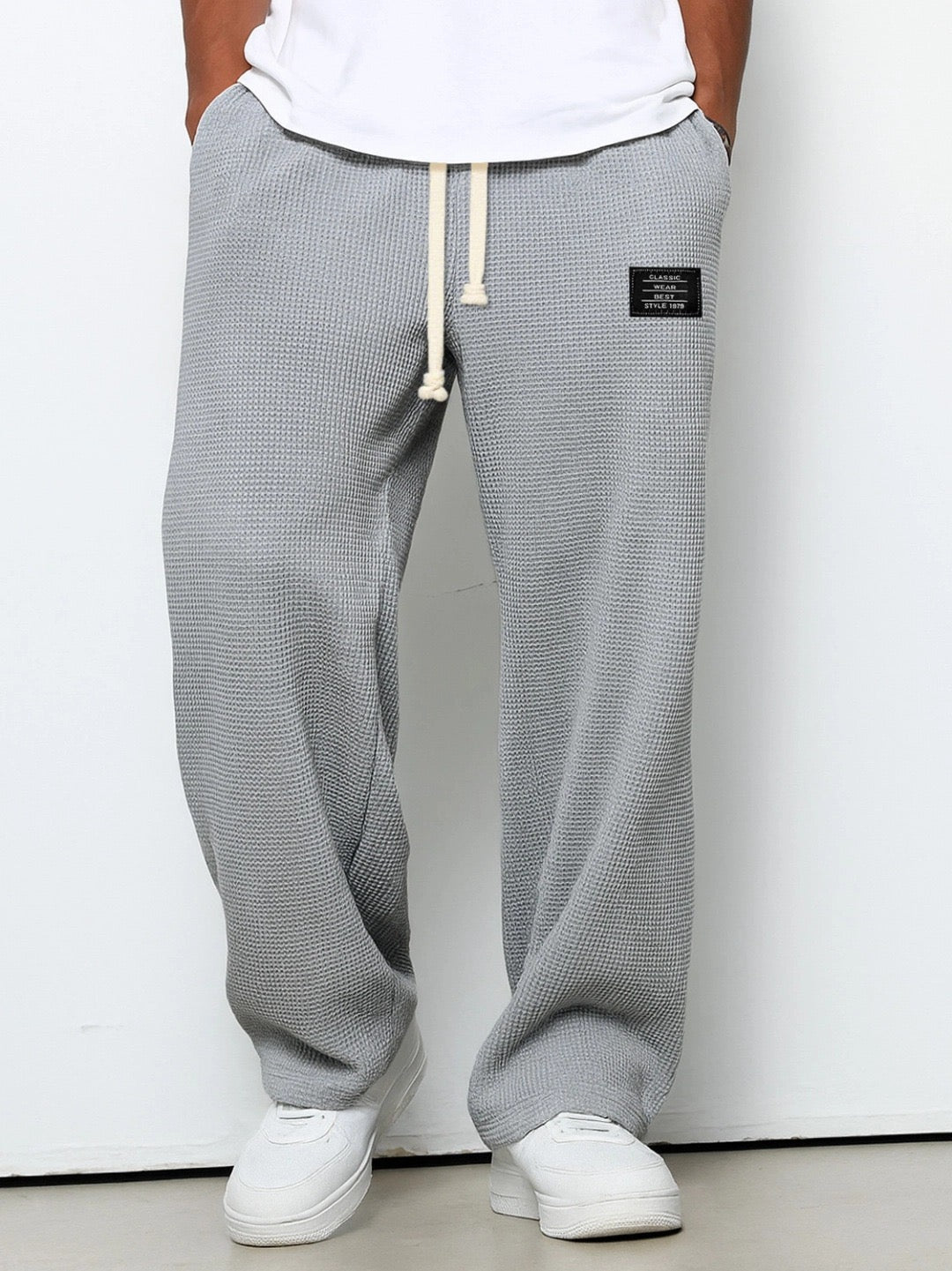 Close-up of the adjustable drawstring waist on men's relaxed wide leg sweatpants