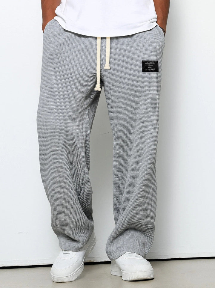Close-up of the adjustable drawstring waist on men's relaxed wide leg sweatpants