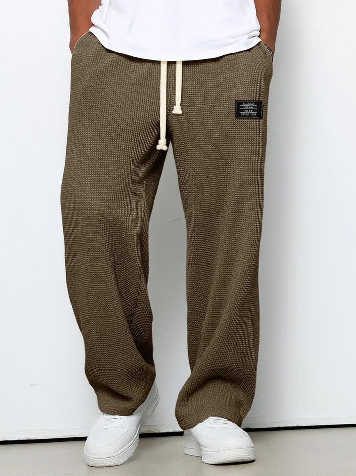 Back view of men's relaxed fit wide leg sweatpants, ideal for everyday comfort