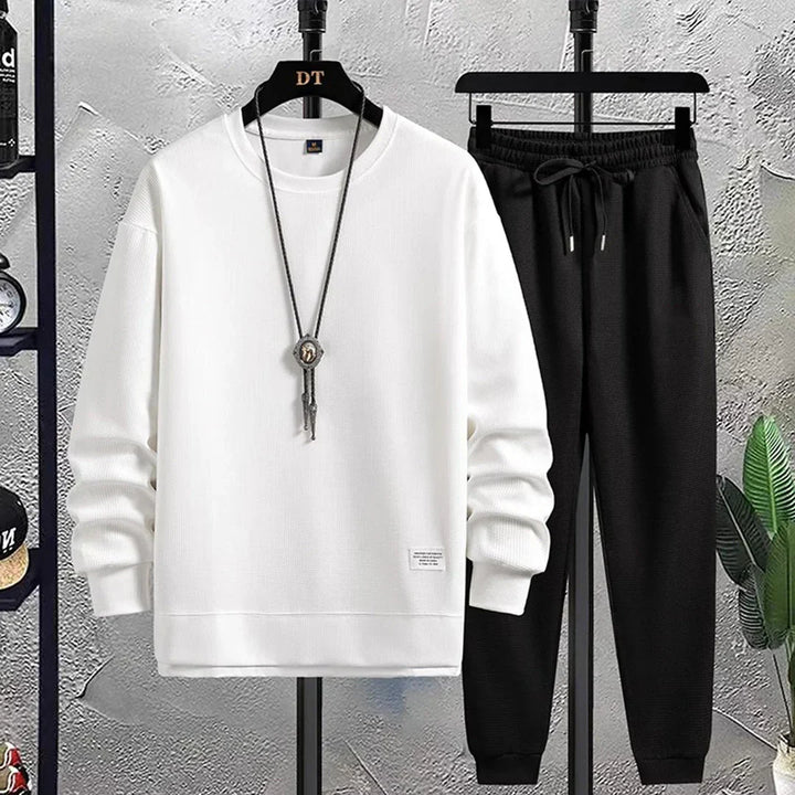 Men's relaxed sporty tracksuit. Comfortable pullover top & joggers for activewear or casual style.