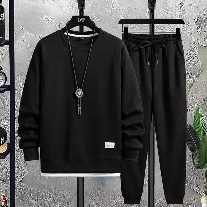 Modern men's two-piece tracksuit. Stylish relaxed fit pullover and joggers for comfort and active fashion.