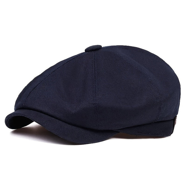 Detailed herringbone pattern on a men's retro flat cap, vintage style.