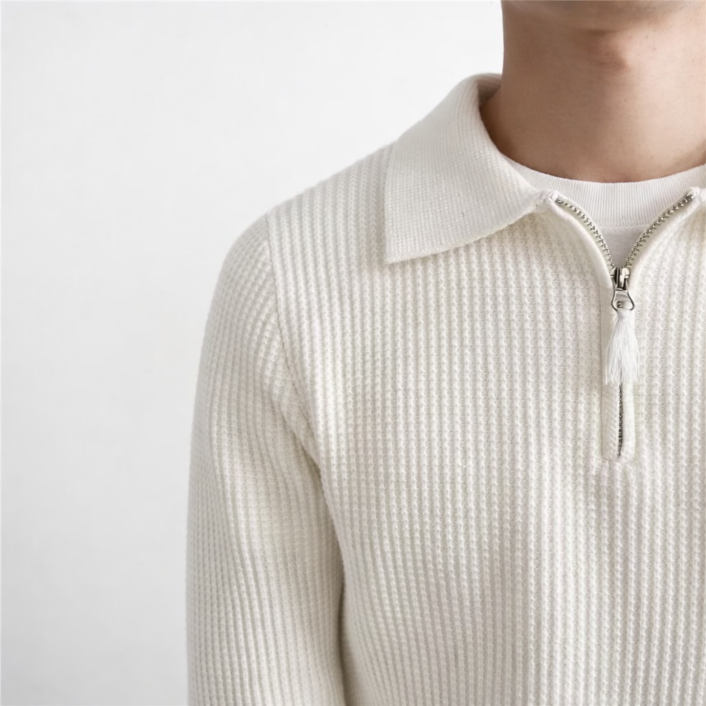 Close-up of a men's collared quarter zip sweater, showcasing the stylish ribbed knit texture and comfortable fit.