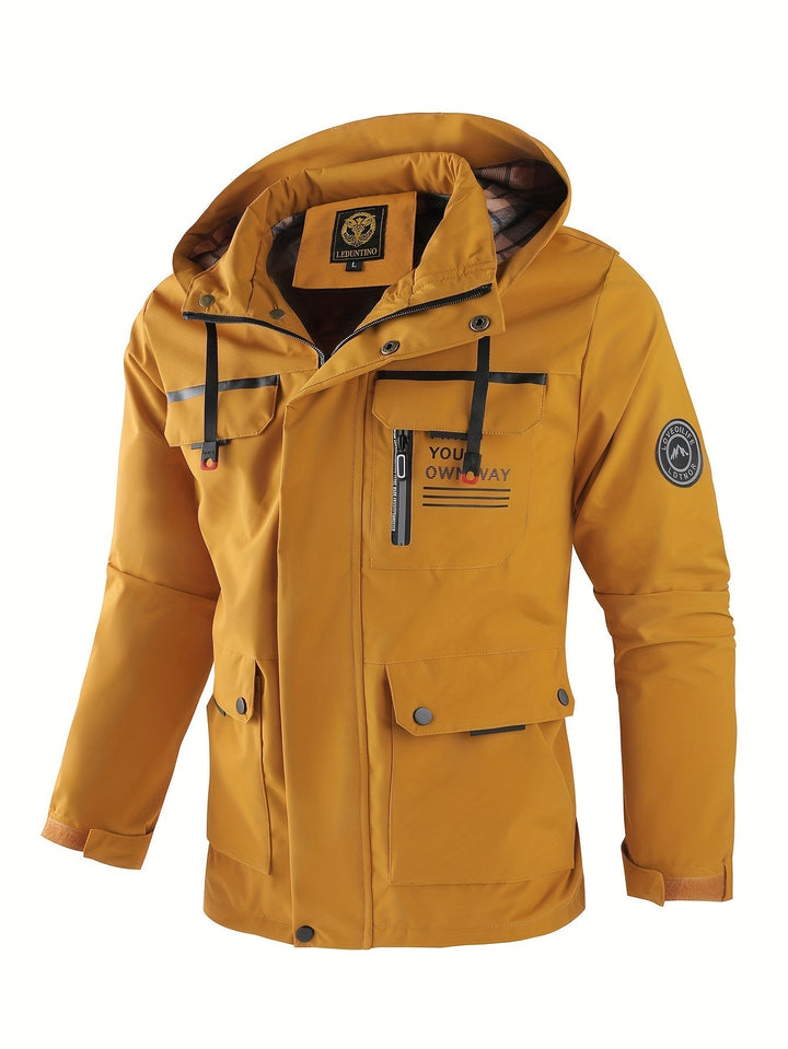 Close-up of the zipper and pockets on a men's rugged waterproof outdoor winter coat.