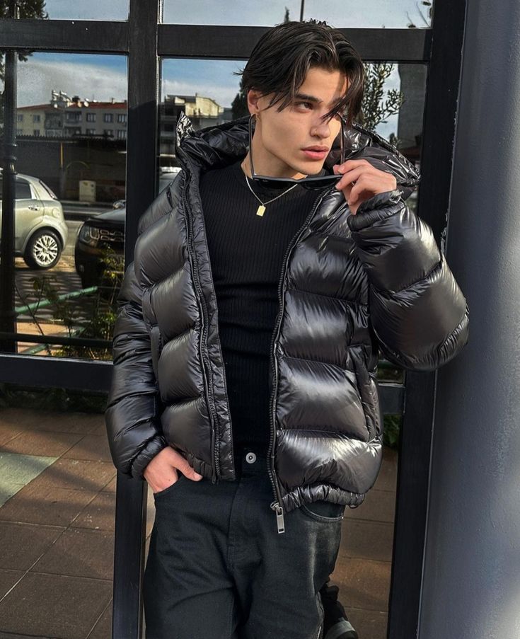 Stylish men's black shiny hooded puffer jacket, warm and fashionable for cold weather.