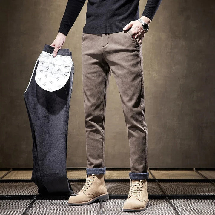 Full-length shot of men's slim-fit casual chino pants in navy, showcasing their modern fit.