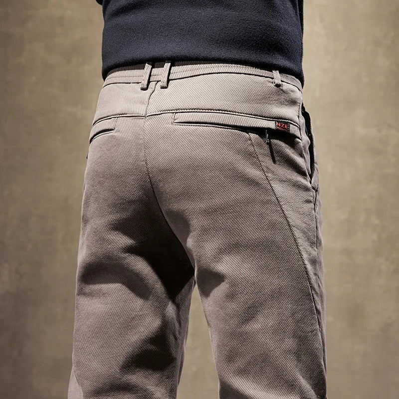 Back view of men's slim-fit casual chino pants in grey, emphasizing the comfortable and modern design.
