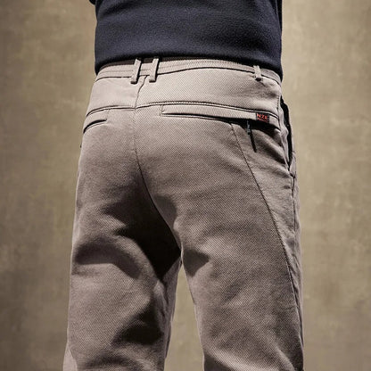 Back view of men's slim-fit casual chino pants in grey, emphasizing the comfortable and modern design.