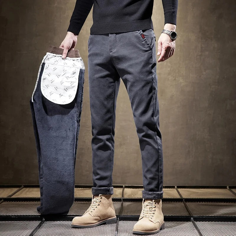 Model wearing men's slim-fit casual chino pants in an active pose, highlighting comfort and flexibility.