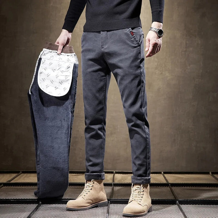 Model wearing men's slim-fit casual chino pants in an active pose, highlighting comfort and flexibility.