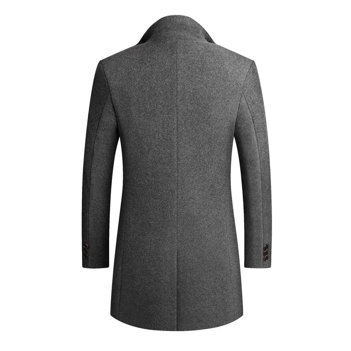 Detail of a men's elegant winter coat, showcasing the slim fit, tailored cut, and classic button front.