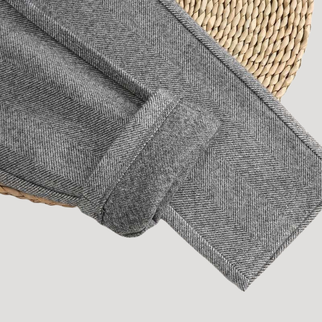 Stack of men's tailored ankle-length pants in beige, brown, and grey