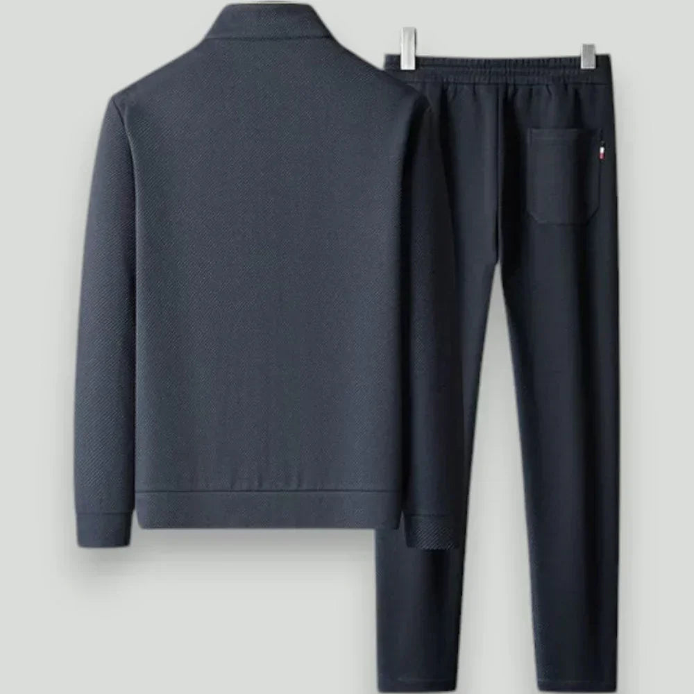 Versatile men's two-piece athletic tracksuit. Includes comfortable joggers & zip-up top for training & casual style.
