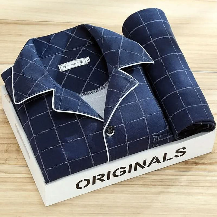 Neatly folded men's button-up pajama set, a comfortable and stylish sleepwear gift for him.