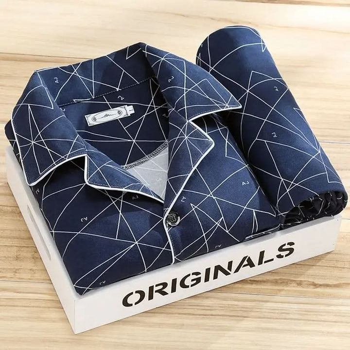 Man reading in a cozy men's button-up pajama set, ultimate loungewear comfort for relaxing evenings.