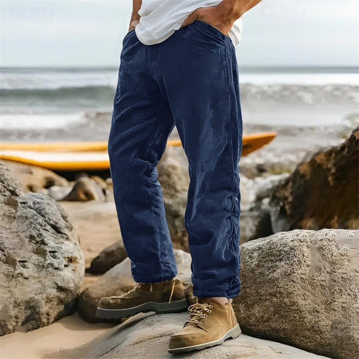 Man wearing comfortable men's straight leg ribbed trousers with a casual top, perfect for everyday versatile fashion.