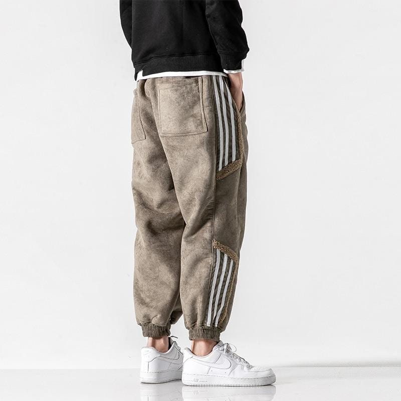 Close-up of black relaxed fit jogger pants for men, highlighting the fabric and streetwear style