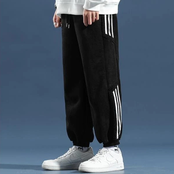 Two pairs of men's jogger pants, black and brown, demonstrating their relaxed fit and streetwear style