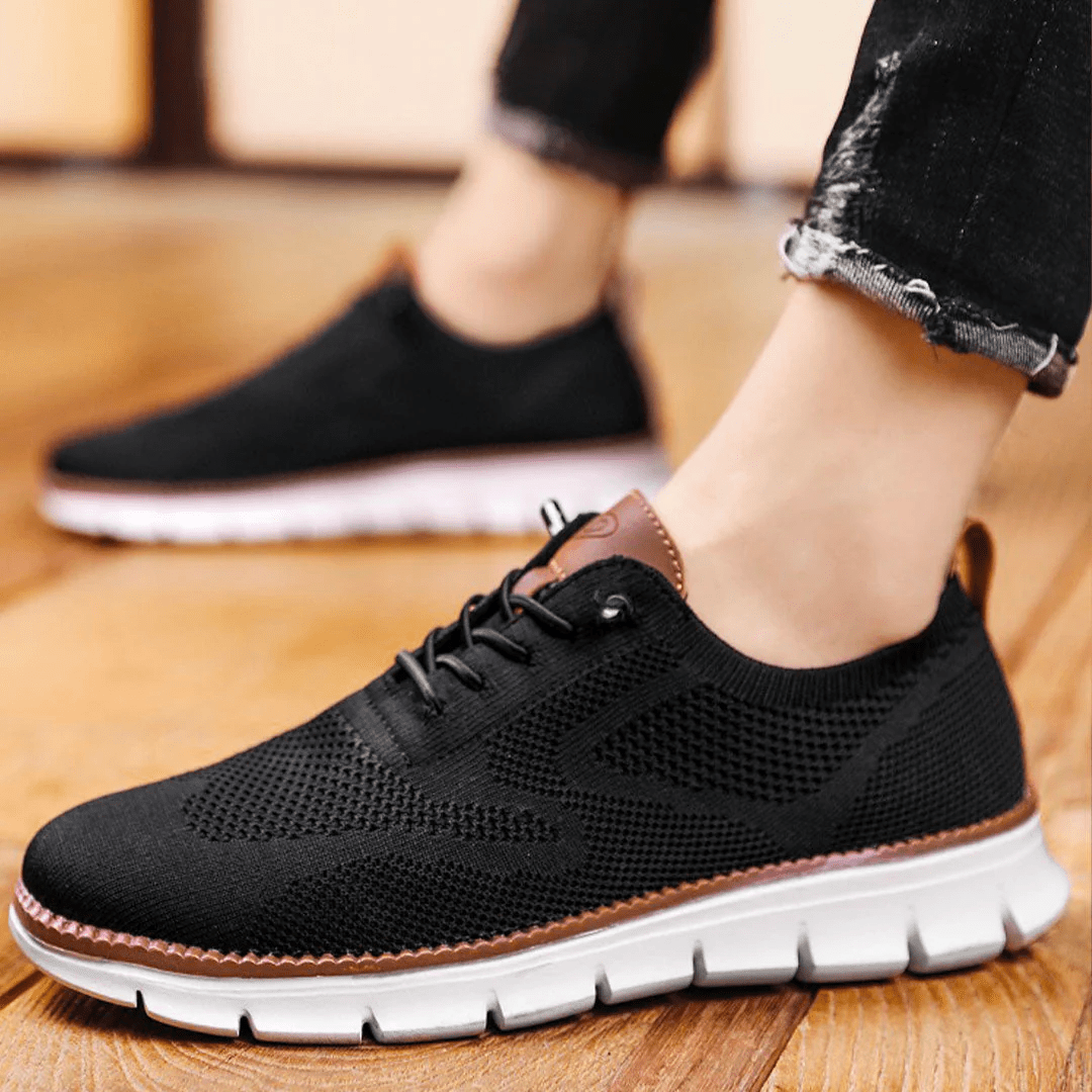 Perforated men's lace-up sneakers, breathable & comfortable for spring/summer casual wear.