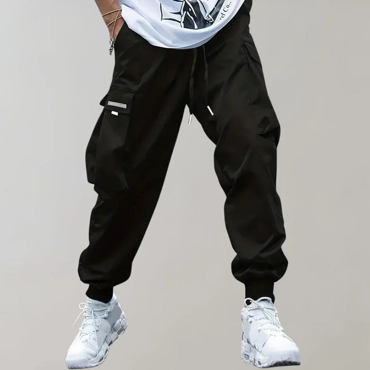 Black men's cargo pants with a modern fit, offering utility and street style. Durable and stylish.