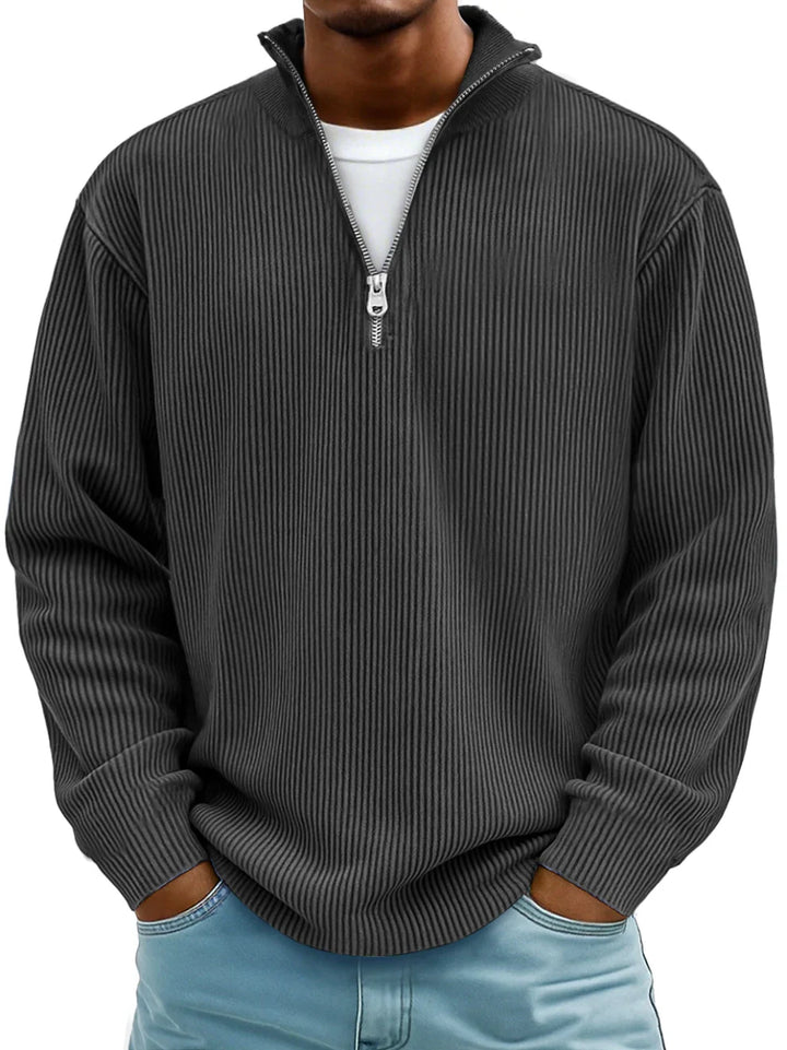 Model wearing a men's half-zip ribbed sweater, suitable for a relaxed yet polished look.
