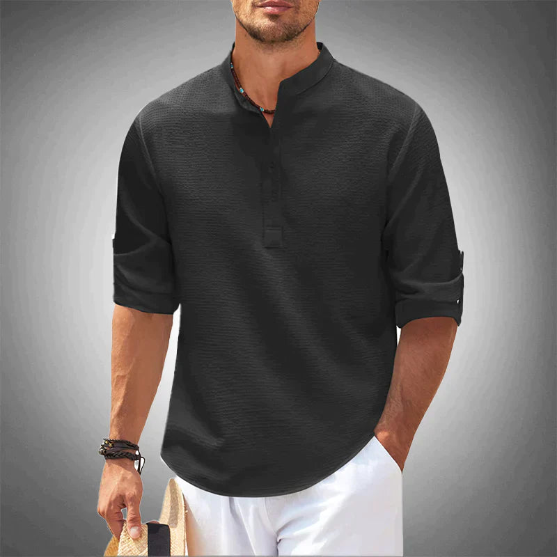 Close-up of a new men's white button-down shirt, showing fabric and tailored fit details. Modern spring style.