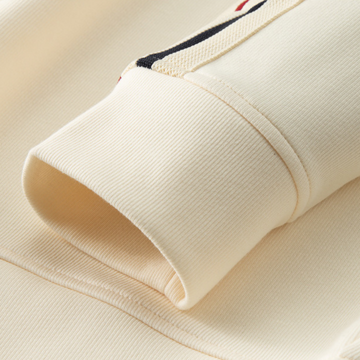 Product flat lay of a men's stylish zip-up hoodie & joggers tracksuit set, emphasizing the complete outfit.