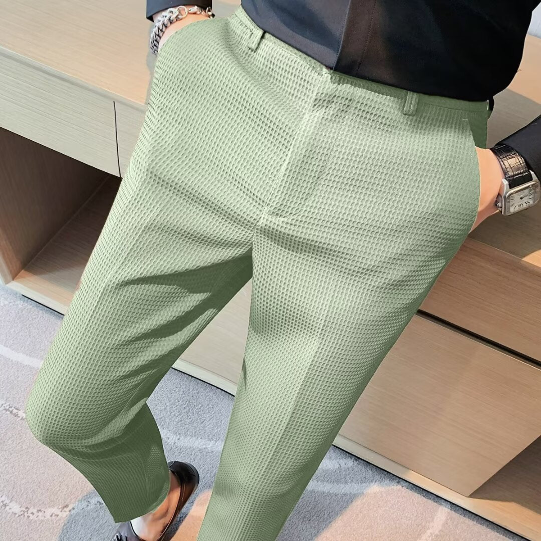 Men's textured slim fit dress trousers in a dark color, perfect for formal or casual chic outfits.