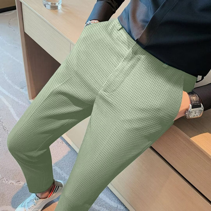 Fashionable men's slim fit trousers with a unique textured weave, designed for contemporary wardrobes.