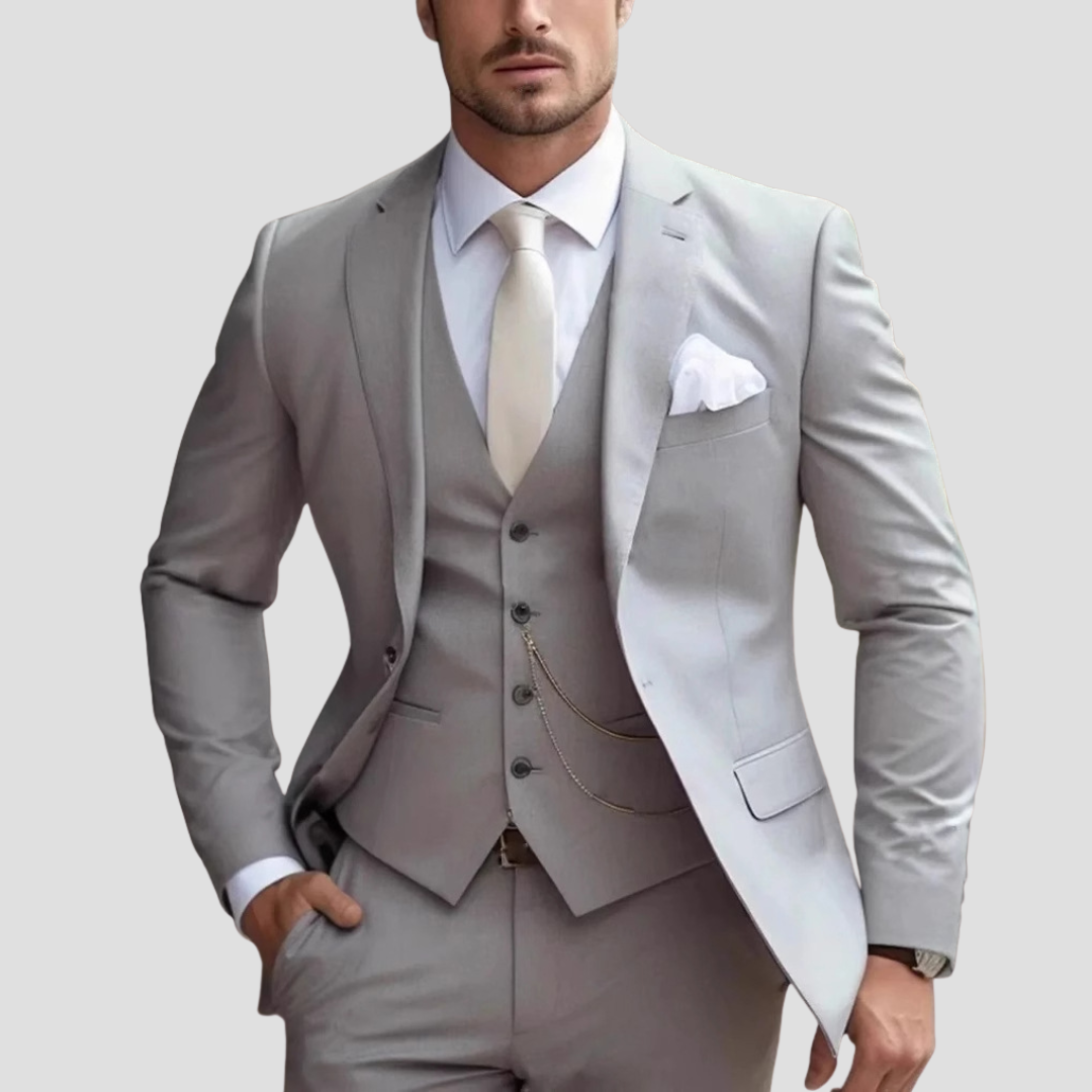 Light grey men's three-piece slim fit formal suit. Tailored for modern business attire or wedding guest.
