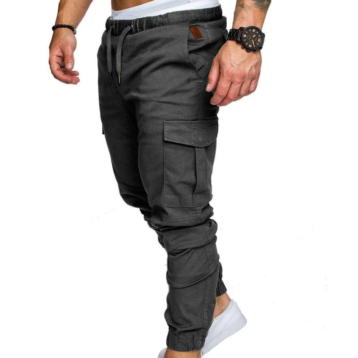 Close-up of men's stylish cargo pants fabric and utility pockets, highlighting quality and modern design.
