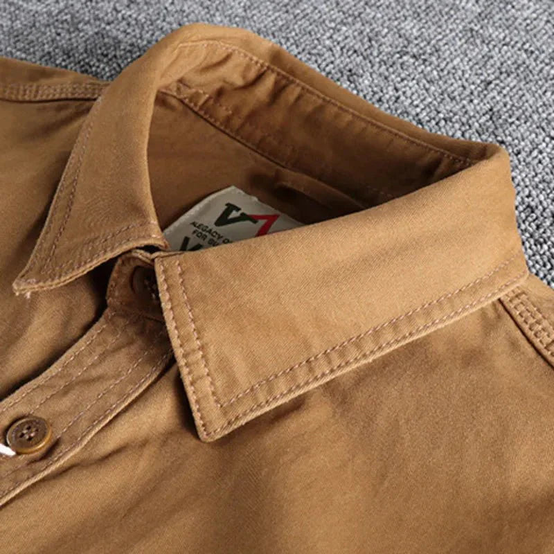 Durable men's utility shirt, long-sleeve button-down, ideal for casual wear, offers versatile style & comfort.