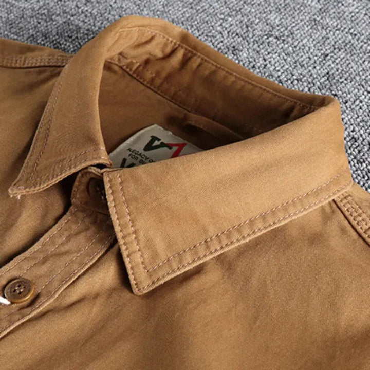 Durable men's utility shirt, long-sleeve button-down, ideal for casual wear, offers versatile style & comfort.